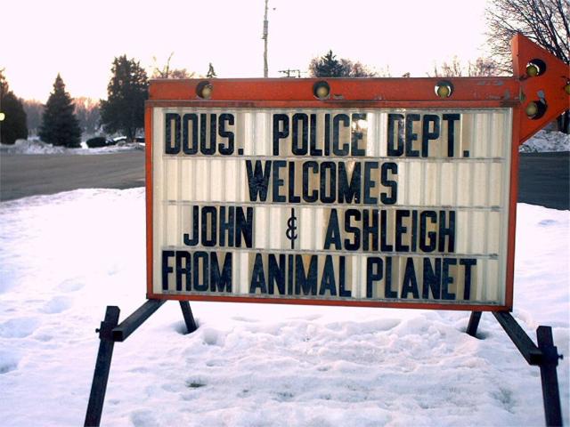 Sign that reads "Dousman Police Department welcomes John and Ashleigh from Animal Planet"